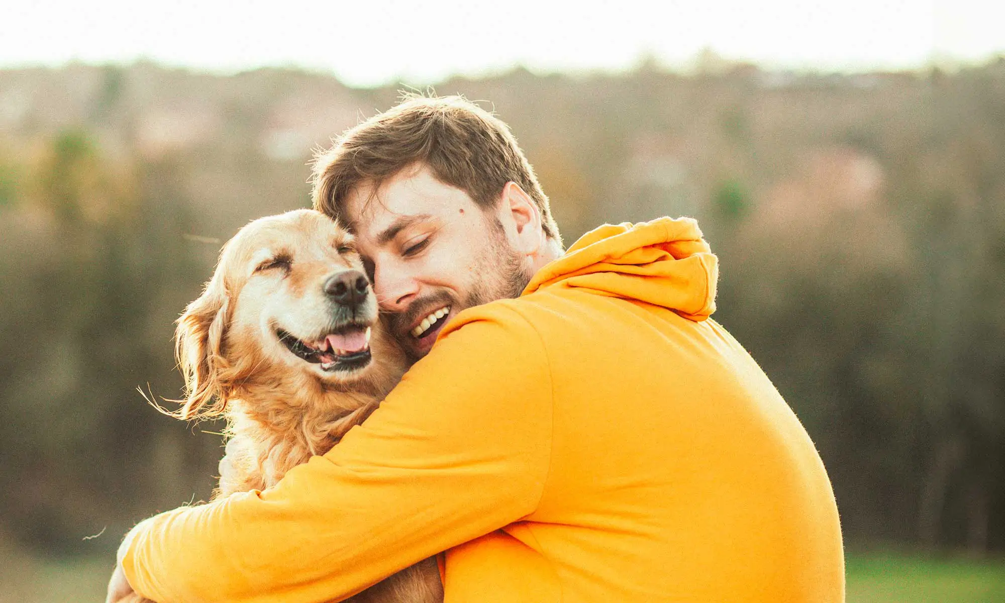 A man hugging his dog